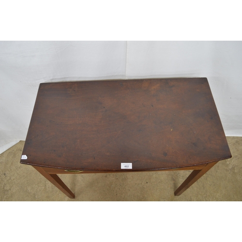 402 - Mahogany side table having a single drawer, standing on square supports - 78cm x 43cm x 71cm tall