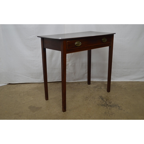 402 - Mahogany side table having a single drawer, standing on square supports - 78cm x 43cm x 71cm tall