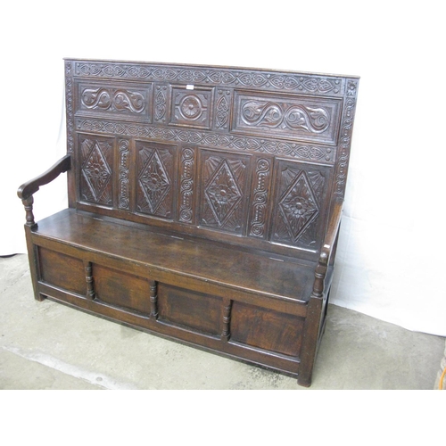 404 - 18th century carved oak box settle having five panel back carved with scrolled floral and lozenge de... 