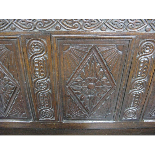 404 - 18th century carved oak box settle having five panel back carved with scrolled floral and lozenge de... 