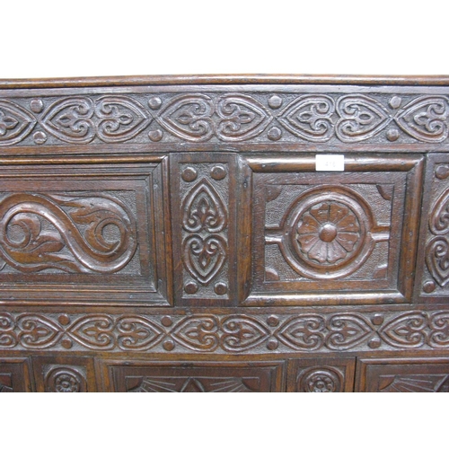 404 - 18th century carved oak box settle having five panel back carved with scrolled floral and lozenge de... 