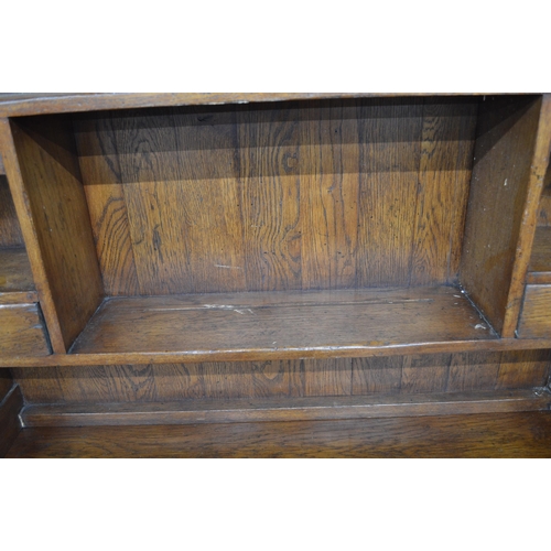 410 - Oak dresser, the top section having shaped frieze over two plate shelves with two small drawers, the... 