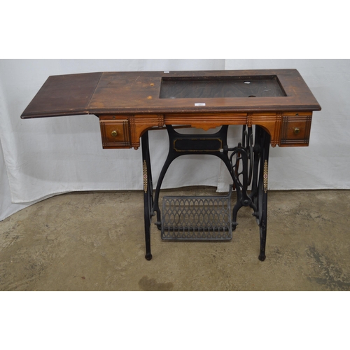 413 - Cast iron treadle sewing machine table having a wooden top with two drawers and drop flap - 88.5cm x... 