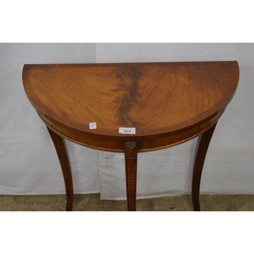 414 - Reproduction cross banded mahogany demi lune side table, standing on shaped tapering legs - 61cm x 3... 