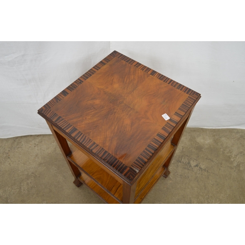 415 - Cross banded walnut three tier lamp table, standing on square legs with carved pad feet - 38cm x 38c... 