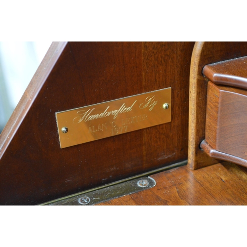 417 - Mahogany bureau made by Alan Dexter in 1977, the fall front opening to a sliding compartment of pige... 