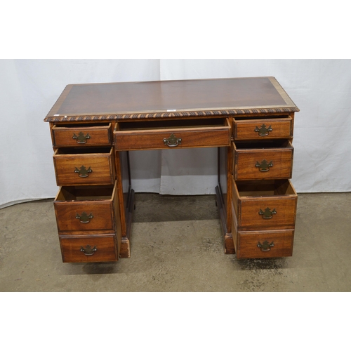 419 - Mahogany twin pedestal desk, the inset leatherette top with gadrooned edge over an arrangement of se... 