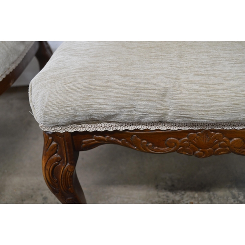 427 - Pair of carved upholstered bedroom chairs having padded button backs and seats, standing on carved c... 