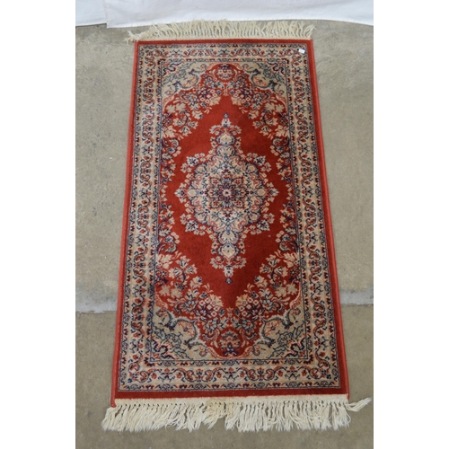 428 - Red and blue ground patterned rug having central repeating geometric pattern surrounded by patterned... 