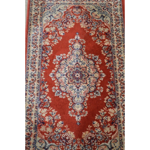 428 - Red and blue ground patterned rug having central repeating geometric pattern surrounded by patterned... 