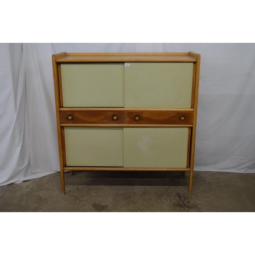 433 - Heals mid century beech sideboard having 3/4 galleried top with two cupboards above and below two ce... 