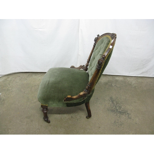 435 - Carved green upholstered nursing chair having button back and padded seat, standing on turned front ... 