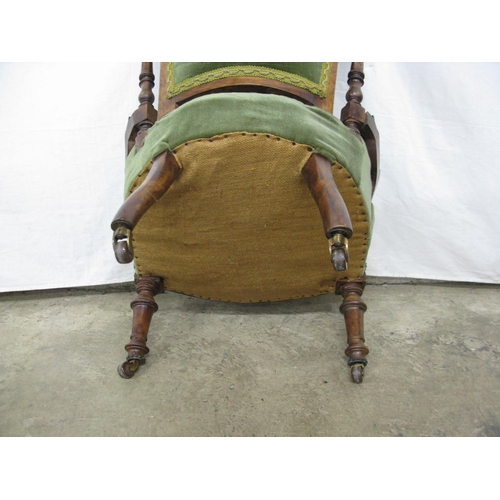 435 - Carved green upholstered nursing chair having button back and padded seat, standing on turned front ... 