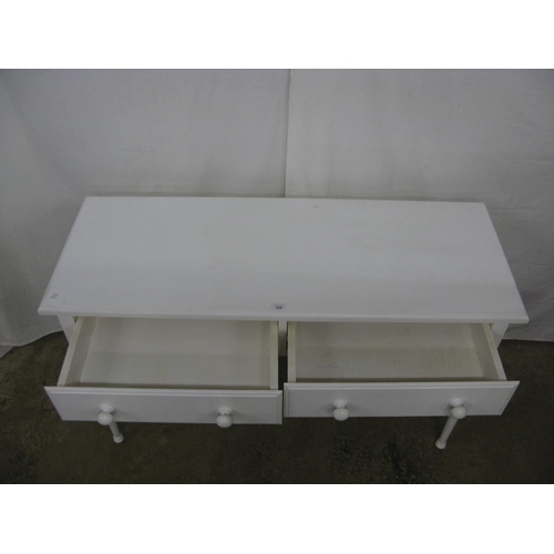 439 - Modern white painted two drawer side table, standing on turned legs - 122cm x 46cm x 76cm tall