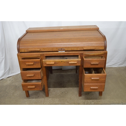 445 - Oak roll top twin pedestal desk, the tambour front opening to a single drawer and an arrangement of ... 