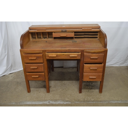 445 - Oak roll top twin pedestal desk, the tambour front opening to a single drawer and an arrangement of ... 