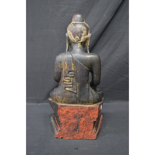 87 - Carved wooden figure of a seated Buddha - 47cm tall