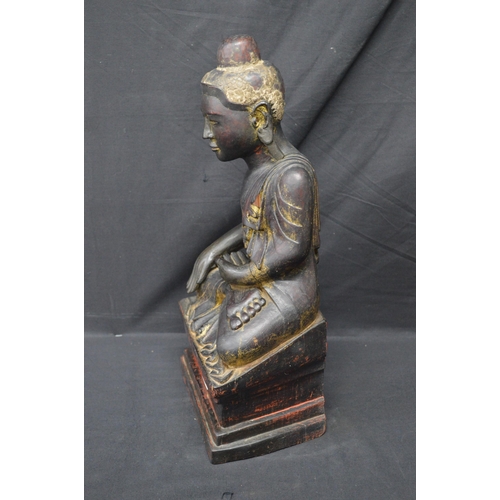 87 - Carved wooden figure of a seated Buddha - 47cm tall