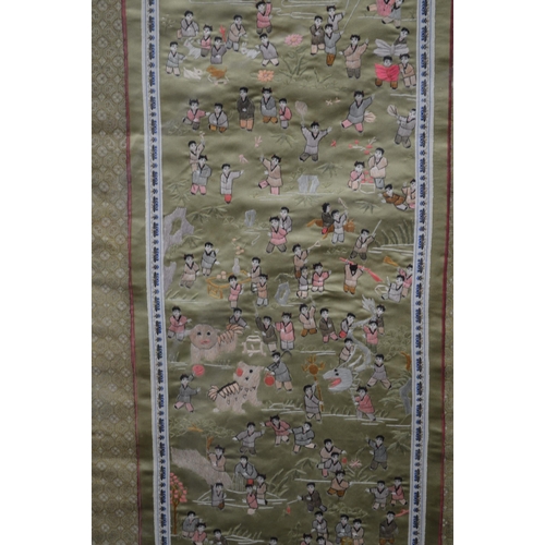 95 - Two silk kimono sleeves embroidered with figures of children playing - 31cm x 66cm and 33.5cm x 66cm... 