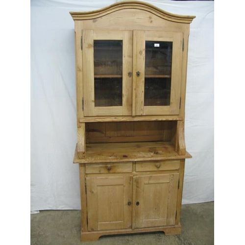 363 - Pine dresser, the upper section having an arched top over two glazed doors opening to a single shelf... 