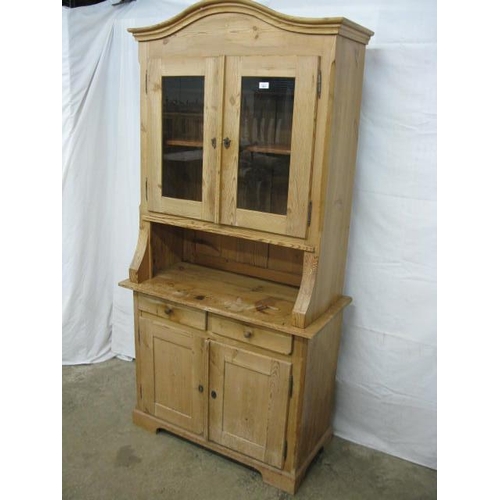 363 - Pine dresser, the upper section having an arched top over two glazed doors opening to a single shelf... 