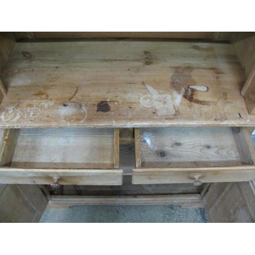 363 - Pine dresser, the upper section having an arched top over two glazed doors opening to a single shelf... 