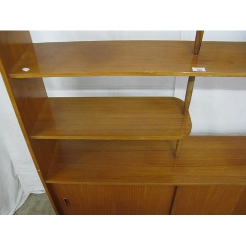 365 - Mid century teak room divider having a central shelf with two half shelves united by turned tapering... 