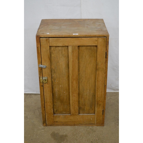 366 - Rustin pine cupboard, the panelled door opening to three shelves - 55cm x 44cm x 87cm tall