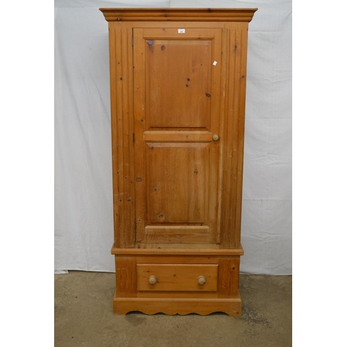 368 - Pine wardrobe, the panelled door opening to a hanging rail and space over a single drawer, standing ... 