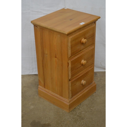 371 - Pine bedside chest of three small drawers, standing on a plinth base - 38cm x 34cm x 66cm tall