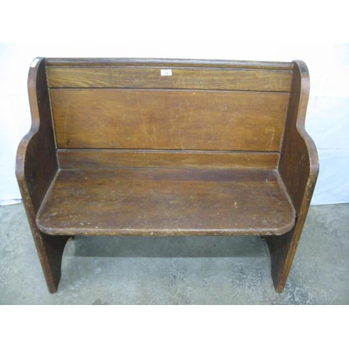 379 - Pine church pew having panelled back and solid seat, standing on shaped end supports - 98cm x 49cm x... 