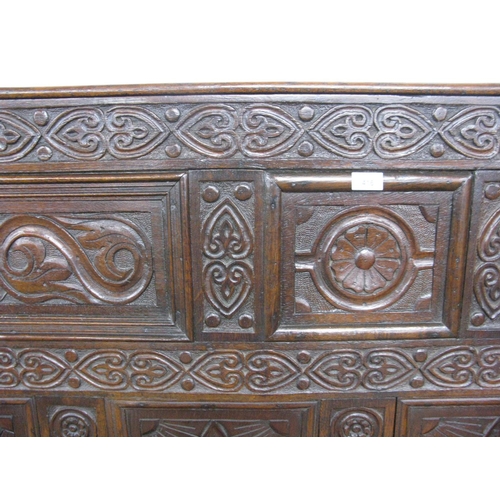 381 - 18th century carved oak box settle having five panel back carved with scrolled floral and lozenge de... 