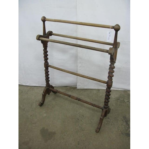 390 - Beech towel rail having four hanging railed united by barley twist supports, standing on splayed fee... 