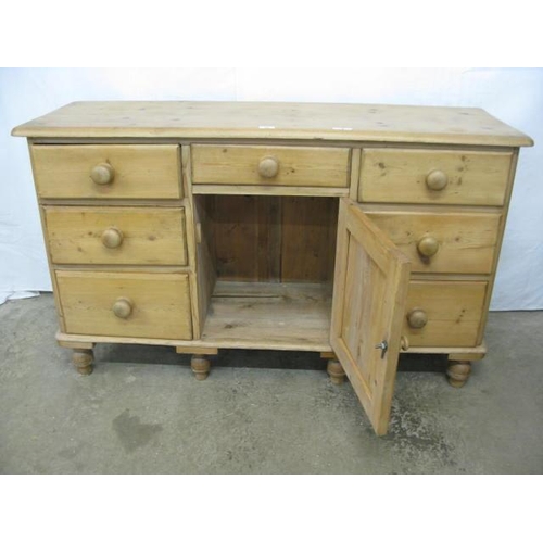 395 - Pine sideboard having a single drawer over a panelled door cupboard flanked by three drawers, standi... 