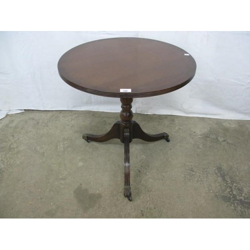 396 - Reproduction inlaid mahogany occasional table, the circular top standing on a turned column with spl... 