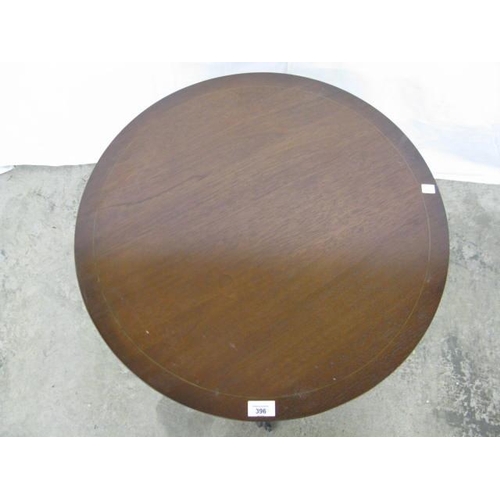 396 - Reproduction inlaid mahogany occasional table, the circular top standing on a turned column with spl... 