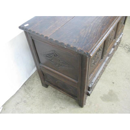 404 - Oak mule chest having a hinged lift top lid opening to storage over a single carved drawer with thre... 