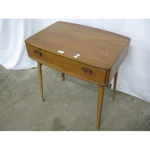 407 - Ercol beech and elm Model 437 desk/side table having a shaped rectangular top over a single drawer w... 