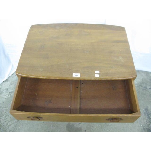 407 - Ercol beech and elm Model 437 desk/side table having a shaped rectangular top over a single drawer w... 