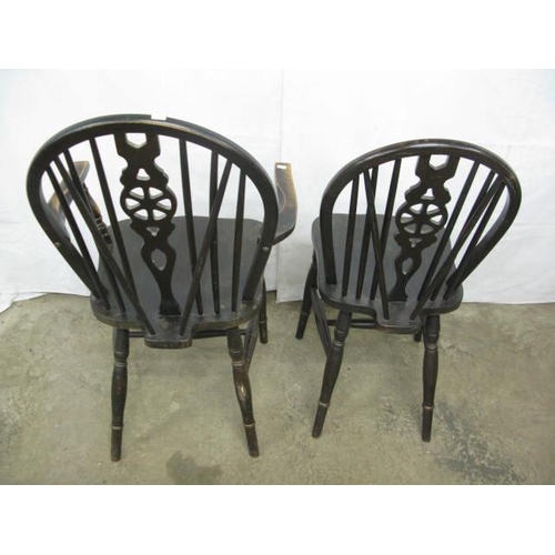 408 - Two stained beech wheelback chairs comprising one standard chair and one carver, both having hoop ba... 