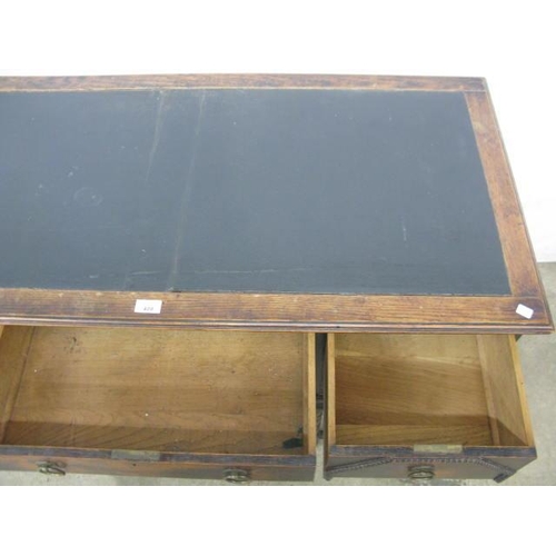 409 - Oak writing desk having an inset leatherette top and an arrangement of five drawers, standing on tur... 