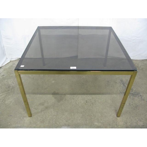 412 - Smoked glass top coffee table standing on square gilt metal legs - 83cm x 83cm x 54cm tall (chips to... 