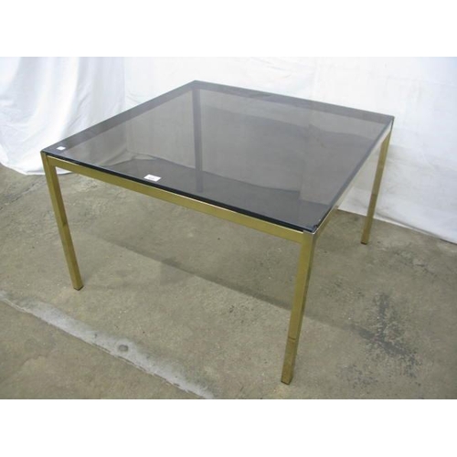 412 - Smoked glass top coffee table standing on square gilt metal legs - 83cm x 83cm x 54cm tall (chips to... 