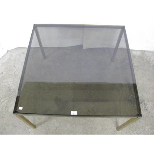 412 - Smoked glass top coffee table standing on square gilt metal legs - 83cm x 83cm x 54cm tall (chips to... 