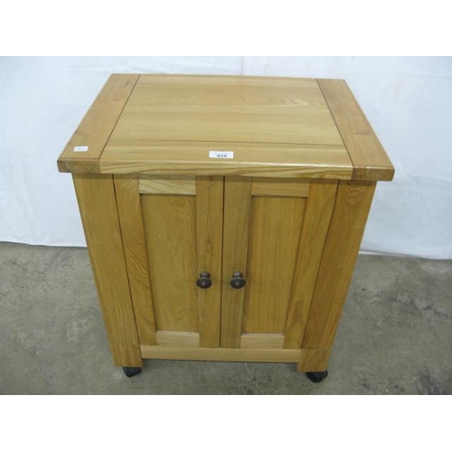 414 - Modern light oak cabinet having two panelled doors opening to open shelves on the reverse of each do... 