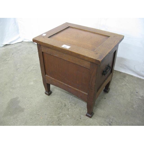 416 - Small oak box having a hinged lift lid with storage below and iron carrying handles, standing on squ... 