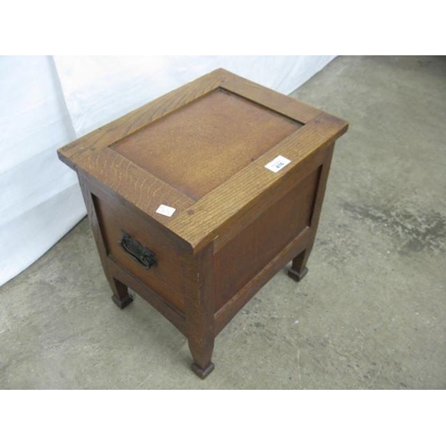 416 - Small oak box having a hinged lift lid with storage below and iron carrying handles, standing on squ... 