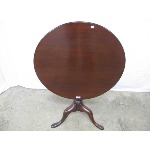 420 - Mahogany tilt top table, the circular top standing on a turned column with splayed tripod supports -... 