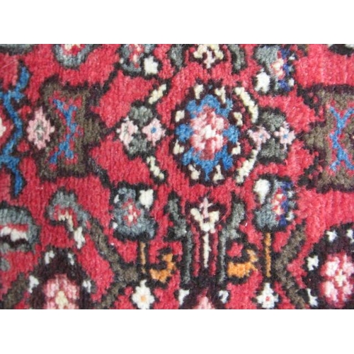 458 - Hamadan red ground patterned runner having a central lozenge design flanked by repeating geometric p... 