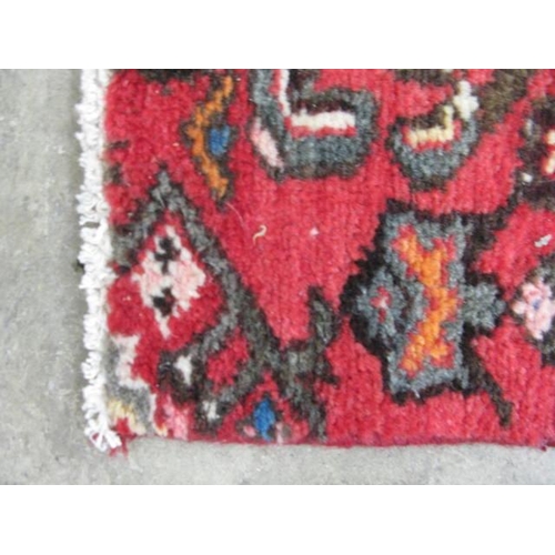 458 - Hamadan red ground patterned runner having a central lozenge design flanked by repeating geometric p... 